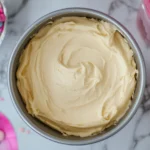 A dome-shaped Barbie cake pan filled with batter, illustrating how many cake mixes for Barbie cake pan?